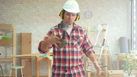 Portrait of a skilled professional man with a drill in his hands and a helmet Stock Footage 105136522