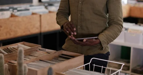 Portrait of small business owner using digital tablet in a record store Stock Footage 87536939