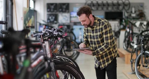 Portrait of a small business owner using digital tablet in a cycle store Video stock 87903660