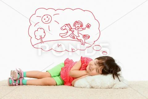 Portrait of small girl lying and dreaming about riding a horse Stock Photos