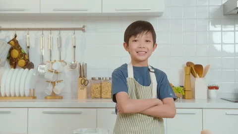 Portrait of smart boy smiling  in kitchen at home Stock Footage 242912270