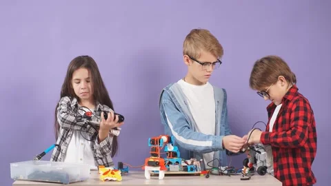 Portrait of smart children aiming to make a robot isolated in studio. Stock Footage 120781569