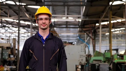 Portrait of smart industry engineer wearing safety glasses and yellow helmet. 動画素材 125290464