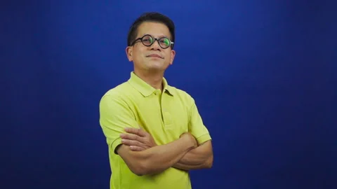 Portrait of smart middle-aged asian man in casual yellow T shirt Stock-Footage 219190081