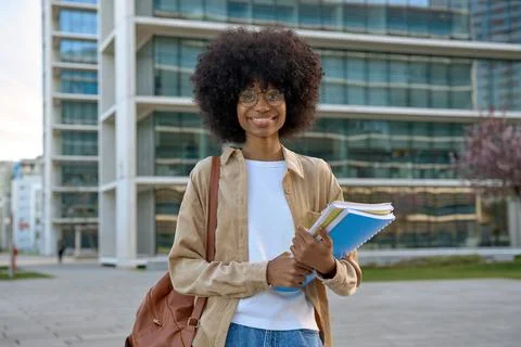 A portrait of a smart student looking aside standing outdoors. Stock Photos