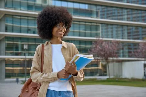 A portrait of a smart student looking aside standing outdoors. Stock Photos