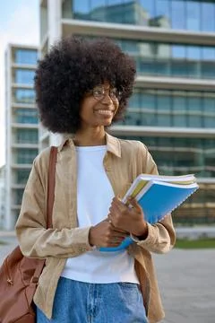 A portrait of a smart student looking aside standing outdoors. Stock Photos