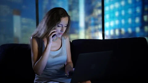 Portrait of smart stylish agent speaking by phone using laptop typing on Stock Footage 95096216