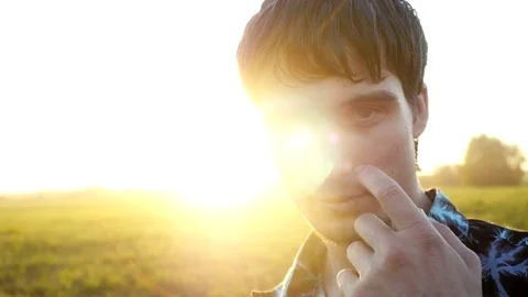 Portrait of smiles man looking at the sun during beautiful sunset with lense 스톡 동영상 72558020
