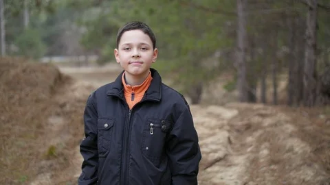 Portrait of smiley boy in the forest 動画素材 104706318