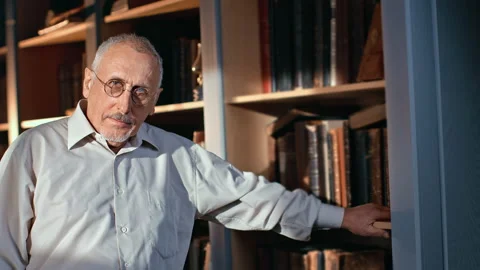Portrait smiling 70s elderly man scientist writer author researcher posing at Stock Footage 162017362