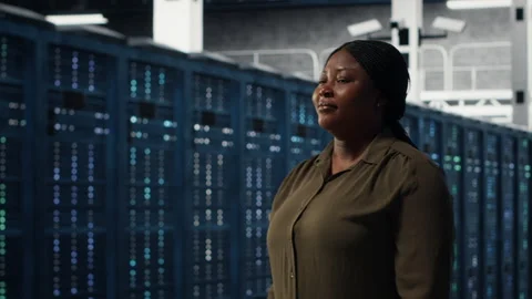 Portrait of smiling admin walking in data center, overseeing IT infrastructure Stock Footage 317125441