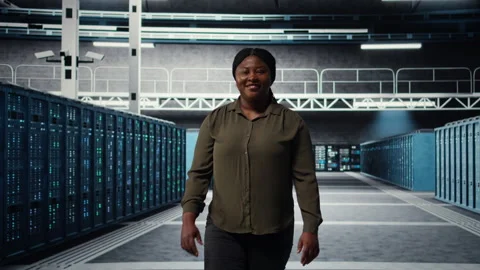 Portrait of smiling admin walking in data center, overseeing IT infrastructure Stock Footage 317204541