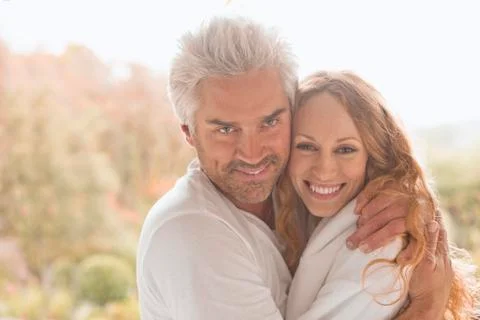 Portrait smiling affectionate couple hugging outdoors Stock Photos