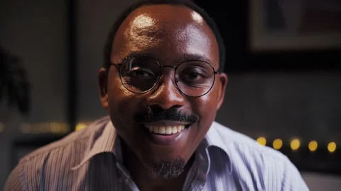 Portrait of smiling African man head shot sitting at table.Smiling person in Stock Footage 209224162