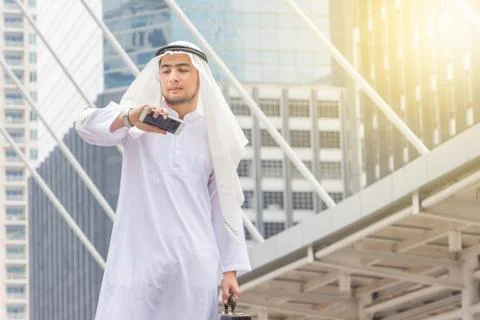 Portrait of Smiling Arab Middle Eastern Businessman checking time Stockfoto's