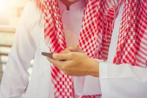 Portrait of Smiling Arab Middle Eastern Businessman using smartphone Фото