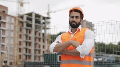 Portrait of smiling architect man standing on the construction site with crossed Stock Footage 110782322