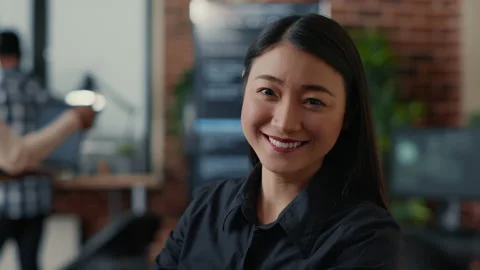 Portrait of smiling asian software developer looking at camera Stock Footage 168233954