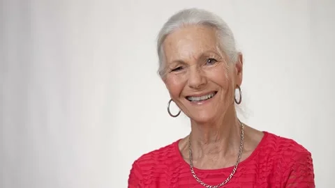 Portrait of smiling attractive sophisticated elderly woman looking at camera Stock Footage 202052013