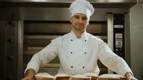 Portrait of smiling attractive worker in bakery shop with tasty bread. Stock Footage