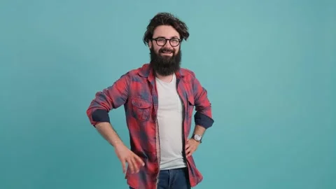 Portrait of smiling bearded man pointing at you over turquoise background. Stock Footage 139692247