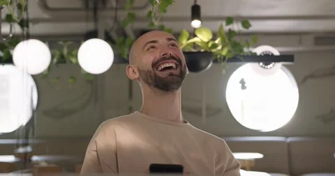 Portrait of smiling bearded man using mobile at cafe Stock Footage 159082474