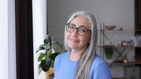 Portrait of smiling beautiful elderly gray-haired woman looking at camera 스톡 동영상 164532969