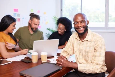 Portrait of smiling Black man, development team, mobile app coding meeting Stock Photos