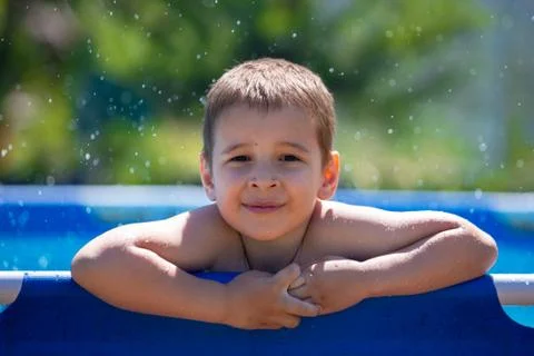 Portrait of a smiling boy. Child in the pool Stock Photos