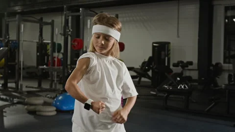 Portrait of Smiling Boy Flexing Biceps to Show Strength in Gym Stock Footage 343381226