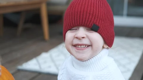 Portrait of a smiling boy in a red hat Stock Footage 252047521