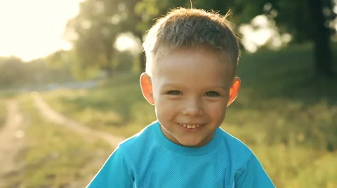 Portrait of smiling boy on sunset Stock Footage 60696867