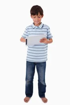 Portrait of a smiling boy using a tablet computer Foto stock
