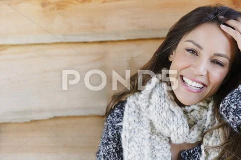 Portrait smiling brunette woman with scarf and hand in hair Stock Photos