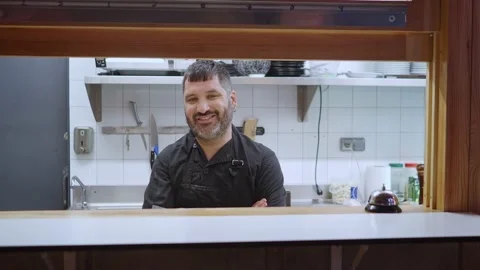 Portrait of a smiling chef looking at camera in a restaurant kitchen Stock Footage 207171888