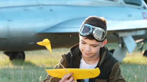 Portrait of smiling child boy plays toy airplane, adventure interest, pilot game Stock Footage 132444732