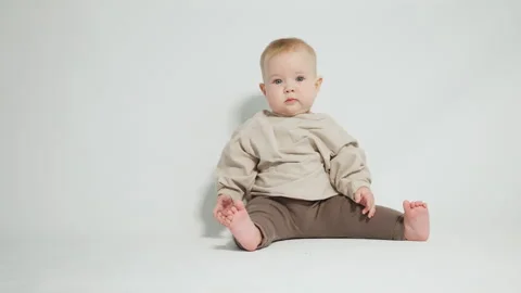 Portrait of a smiling child, on a light studio background Stock Footage 242768136