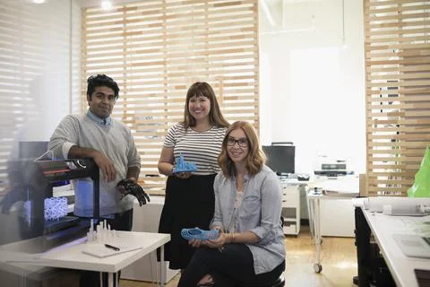 Portrait smiling, confident designers using 3D printer in office Stock Photos