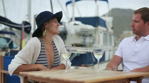 Portrait of smiling couple drinking wine at marina, steadycam shot Video stock 11297998