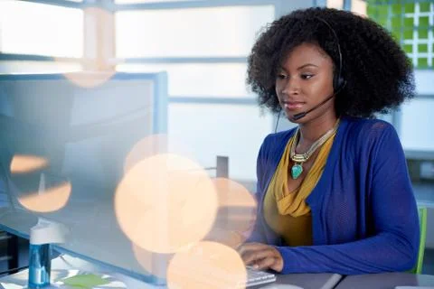 Portrait of a smiling customer service representative with an afro at the Stock Photos