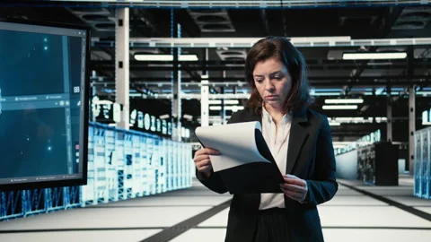 Portrait of smiling data center engineer optimizing equipment rigs using AI Video stock 329323637