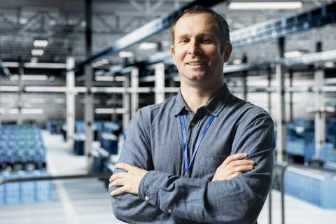 Portrait of smiling data center engineer configuring server settings Stock Photos