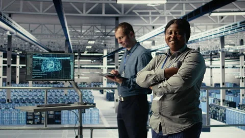 Portrait of smiling data center manager working to improve AI rigs Stock Footage 314684675