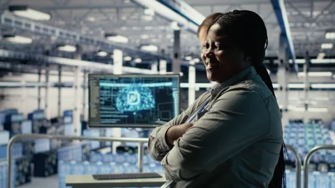 Portrait of smiling data center manager working to improve AI rigs Stock Footage 314685612