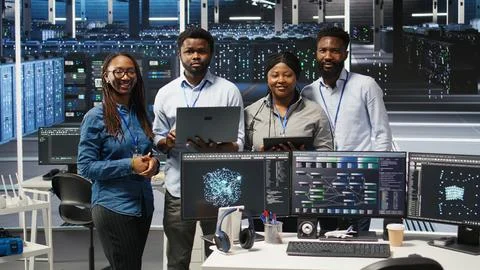 Portrait of smiling data center technicians analyze issues using node tree tool Stock Photos