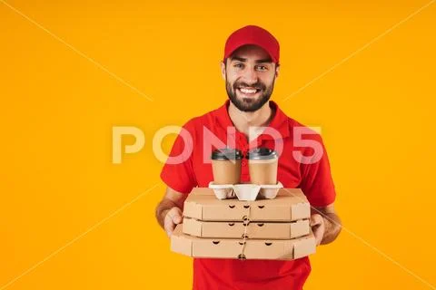 Portrait of smiling delivery man in red uniform holding pizza boxes and takea Stock Photos