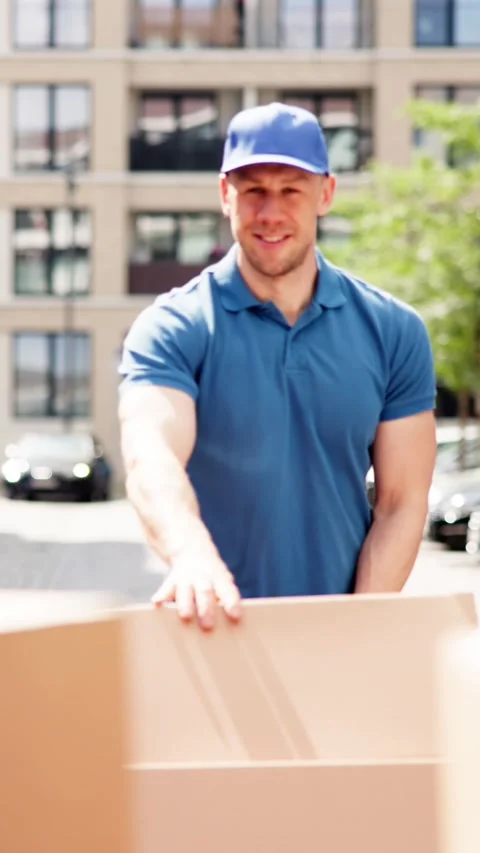 Portrait Of Smiling Delivery Manager Pushing Parcels On Handtruck Against Van Stock Footage 279801766
