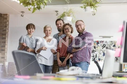 Portrait smiling design professional team in office Stock Photos