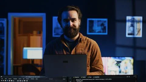 Portrait of smiling developer writing complex binary code scripts on laptop Stockfoto's